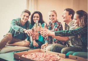 friends giving cheers at pizza party
